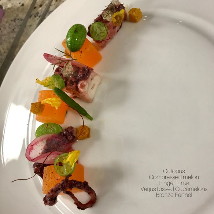 Plated dish: octopus, compressed melon, finger lime